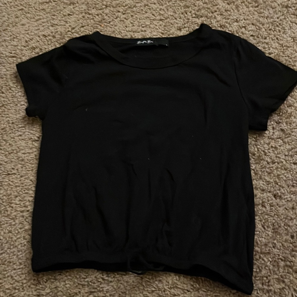 A black crop top with a strip ass well to tie. Good material as well.